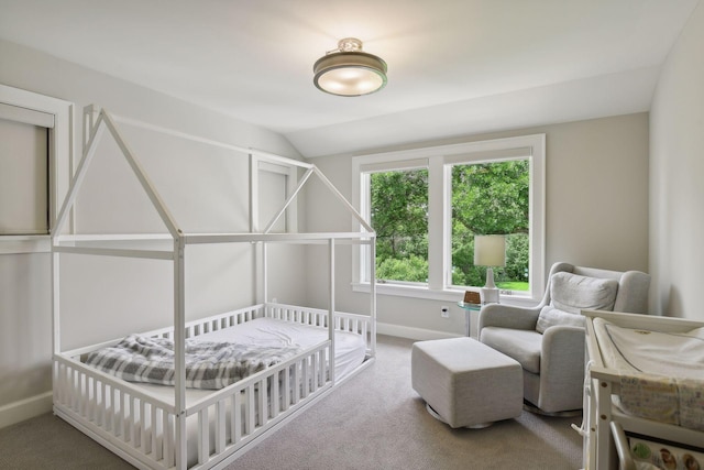 carpeted bedroom featuring lofted ceiling and baseboards