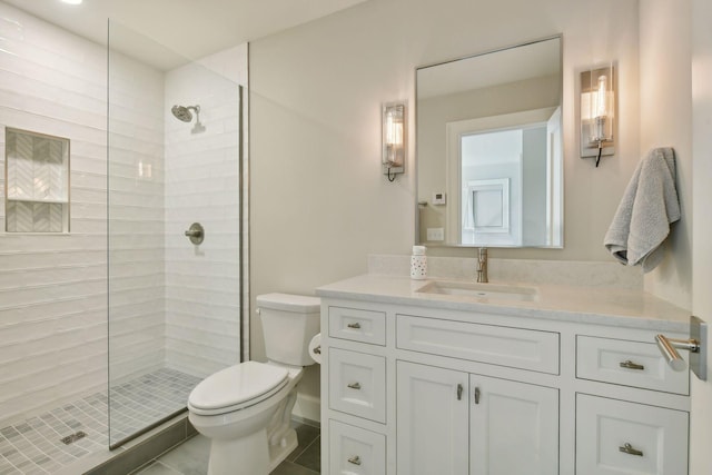 full bathroom with a stall shower, toilet, and vanity