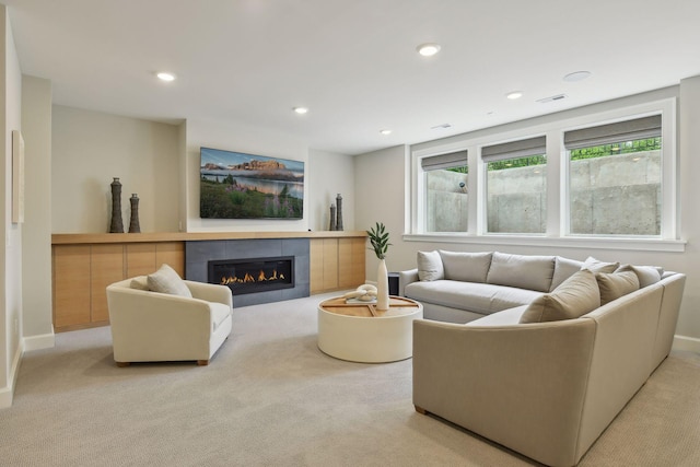 living room with carpet flooring, recessed lighting, baseboards, and a tile fireplace