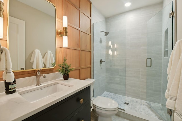 full bath with vanity, a shower stall, and toilet