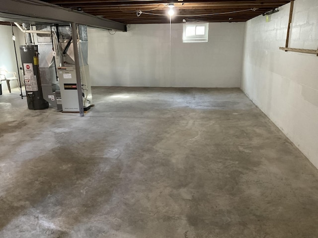 basement featuring heating unit and water heater