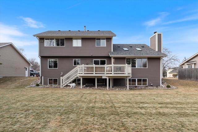 rear view of property featuring a wooden deck, a lawn, a chimney, and stairway