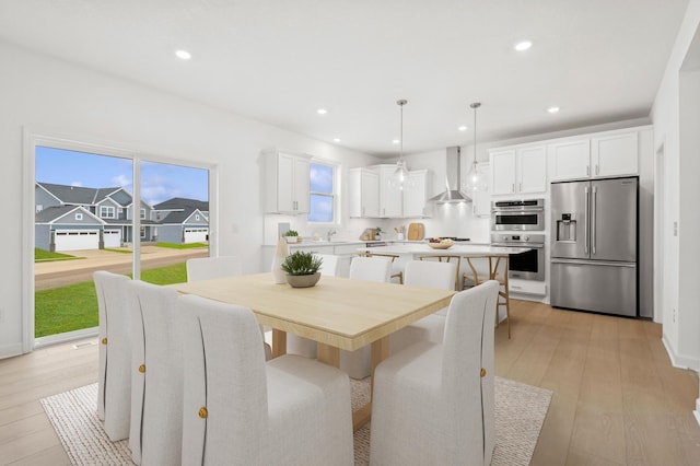 dining space with recessed lighting, baseboards, and light wood finished floors