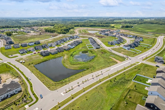 drone / aerial view featuring a water view and a residential view