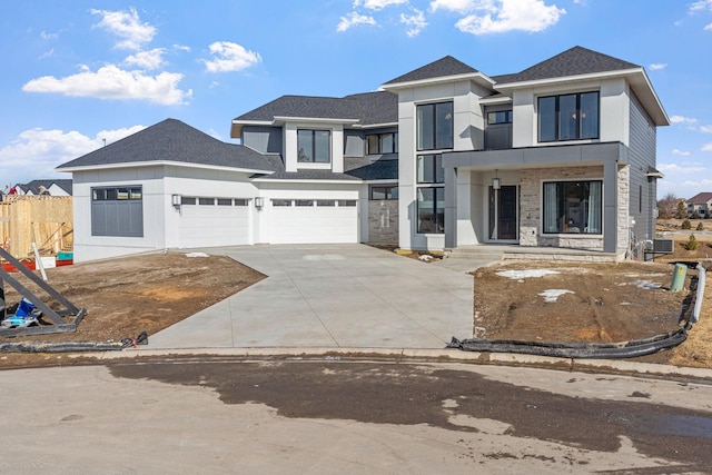 view of front of house with concrete driveway, central AC unit, fence, and a shingled roof