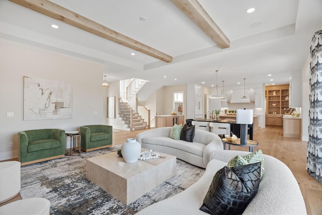 living room featuring stairs, beam ceiling, recessed lighting, and light wood-style floors