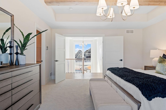 bedroom featuring a tray ceiling, visible vents, a notable chandelier, and light colored carpet