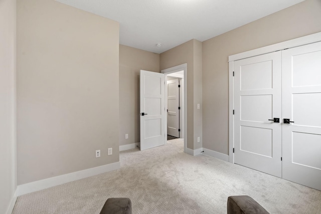 unfurnished bedroom with baseboards and carpet floors