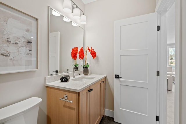 half bathroom with vanity and toilet