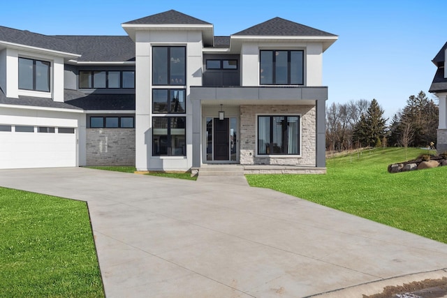 view of front of home featuring a front yard, concrete driveway, stucco siding, stone siding, and roof with shingles