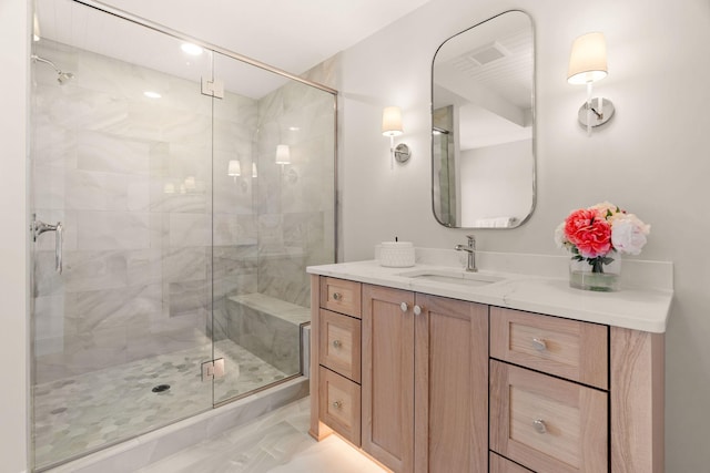 bathroom with vanity, a stall shower, and marble look tile flooring