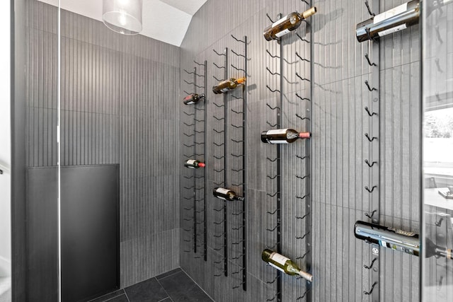 full bathroom with a tile shower and tile patterned floors