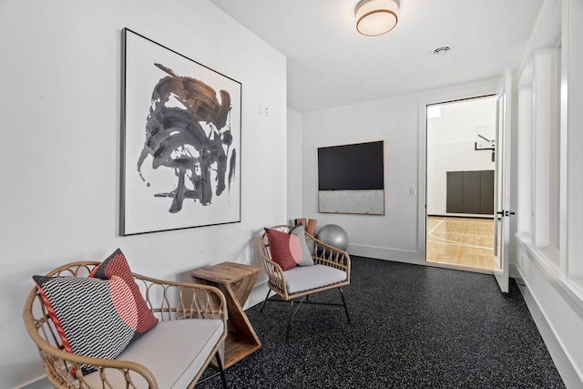living area featuring baseboards
