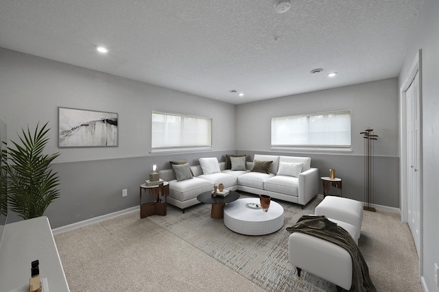 living room featuring a textured ceiling, baseboards, carpet floors, and recessed lighting