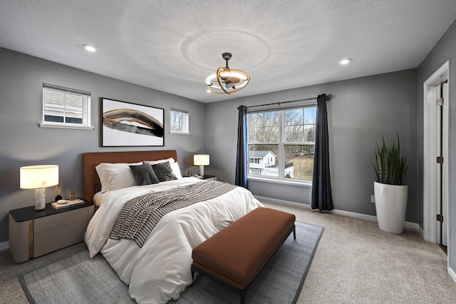 bedroom featuring a textured ceiling, baseboards, recessed lighting, a notable chandelier, and carpet floors