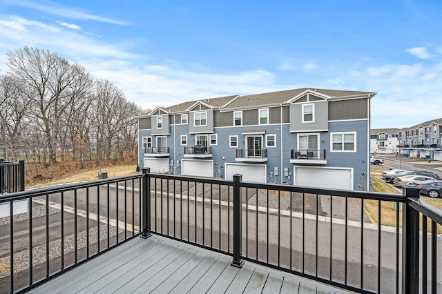 deck with a residential view and an attached garage