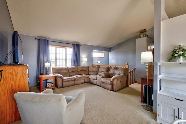 living area with light colored carpet and vaulted ceiling