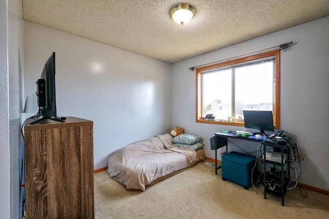 bedroom featuring baseboards, a textured ceiling, and carpet flooring