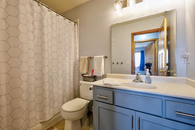 full bathroom with vanity, curtained shower, toilet, and a textured ceiling