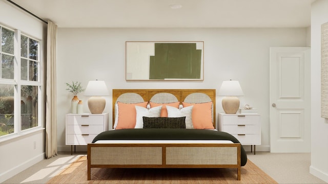 bedroom featuring baseboards, multiple windows, and carpet flooring