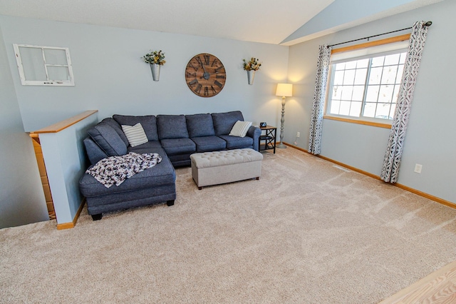 living area featuring baseboards, lofted ceiling, and carpet floors