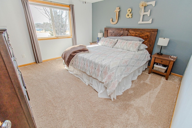 bedroom featuring carpet and baseboards