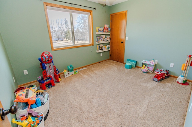 recreation room featuring baseboards and carpet floors