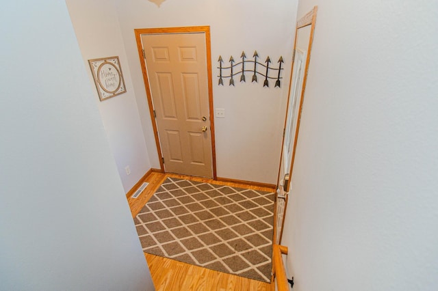 entryway featuring visible vents, light wood-type flooring, and baseboards