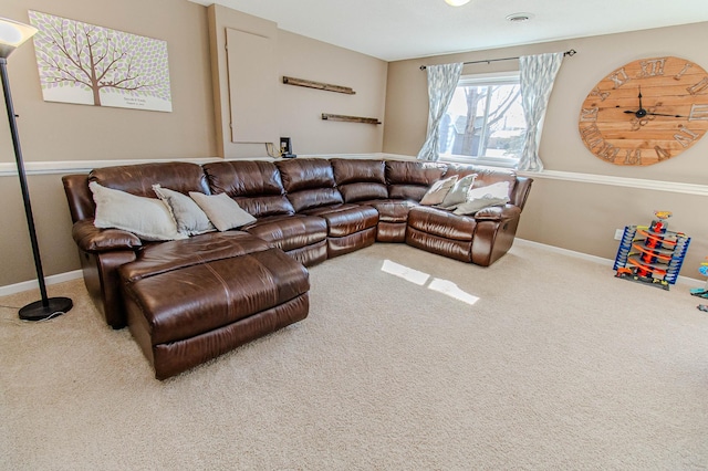 carpeted living area featuring visible vents and baseboards