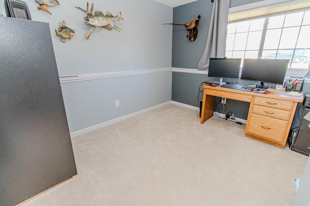 office with baseboards and light colored carpet