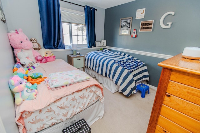 bedroom with baseboards and carpet