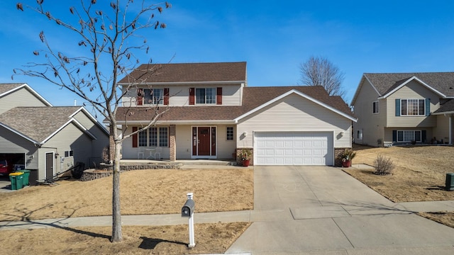 traditional home featuring a porch, concrete driveway, and an attached garage