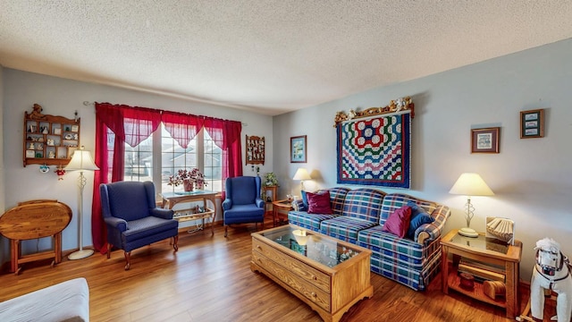 living area with a textured ceiling and wood finished floors