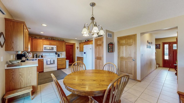 dining area with visible vents, baseboards, an inviting chandelier, light tile patterned flooring, and recessed lighting