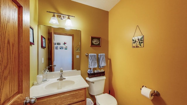 half bath featuring toilet and vanity