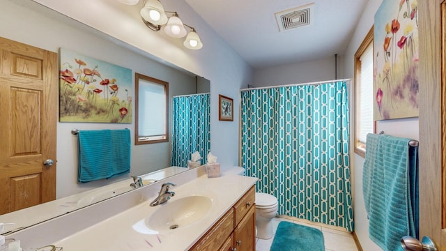 full bathroom featuring visible vents, toilet, curtained shower, tile patterned flooring, and vanity