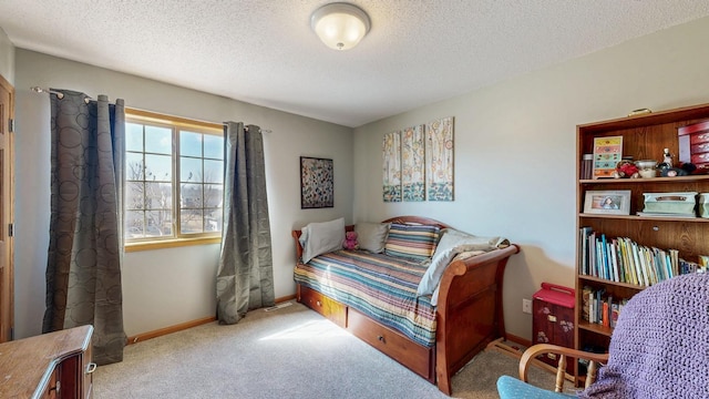 carpeted bedroom with a textured ceiling and baseboards