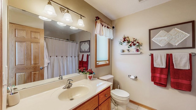 bathroom featuring tile patterned floors, toilet, a shower with shower curtain, and vanity