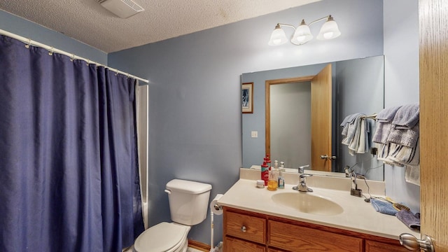 bathroom featuring visible vents, shower / tub combo with curtain, toilet, a textured ceiling, and vanity