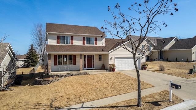 traditional-style house featuring concrete driveway and an attached garage