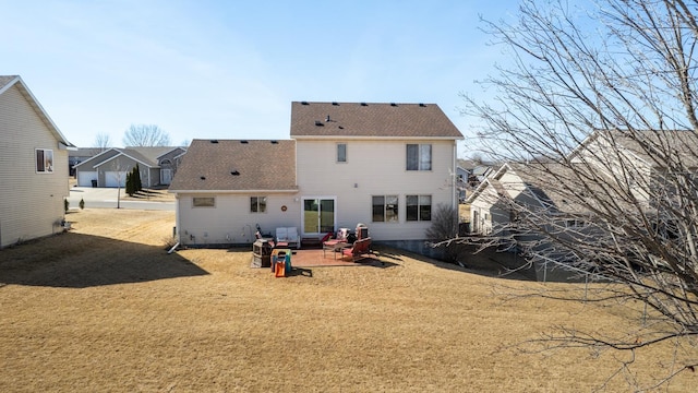 back of house featuring a patio and a shingled roof