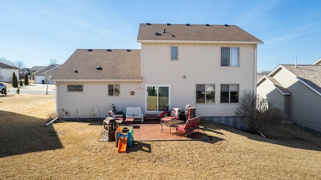 back of house featuring a patio, a yard, and roof with shingles