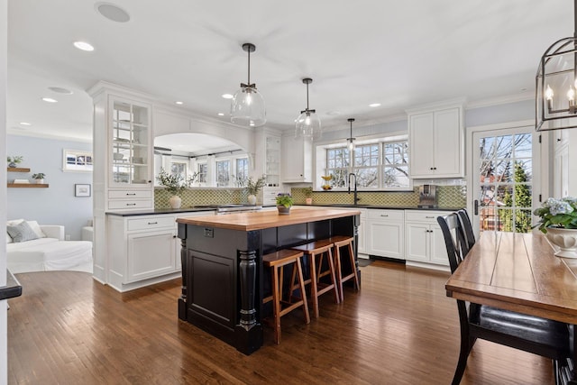 kitchen featuring white cabinets, butcher block counters, and a center island