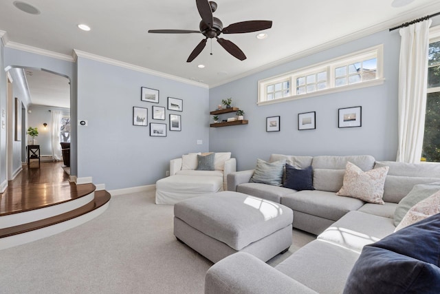 carpeted living area with recessed lighting, baseboards, a ceiling fan, and crown molding