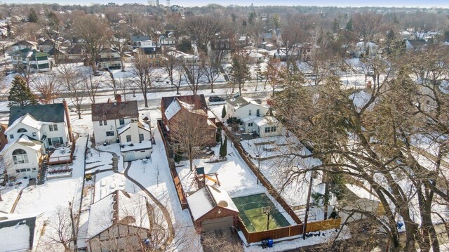 snowy aerial view featuring a residential view