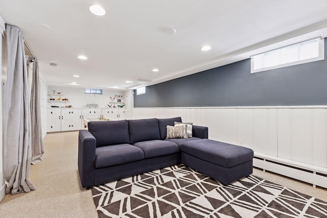 living area featuring a baseboard heating unit, recessed lighting, and wainscoting