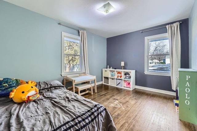 bedroom with baseboards and wood finished floors