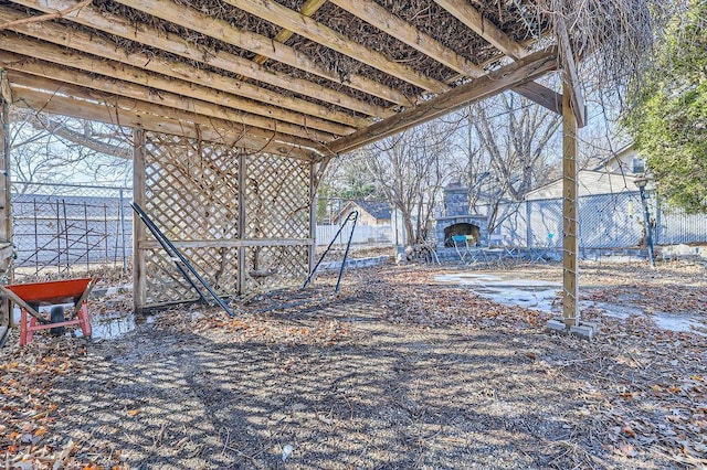 view of yard with a fireplace and fence