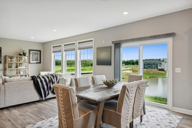 dining area with recessed lighting, baseboards, and light wood-type flooring