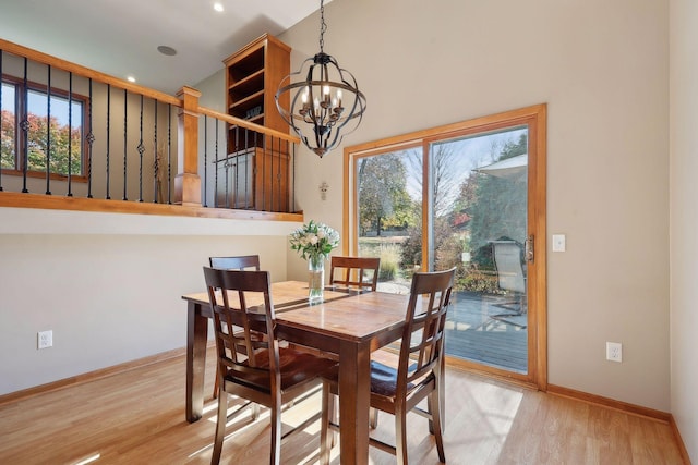 dining area with light wood finished floors, a chandelier, and a wealth of natural light